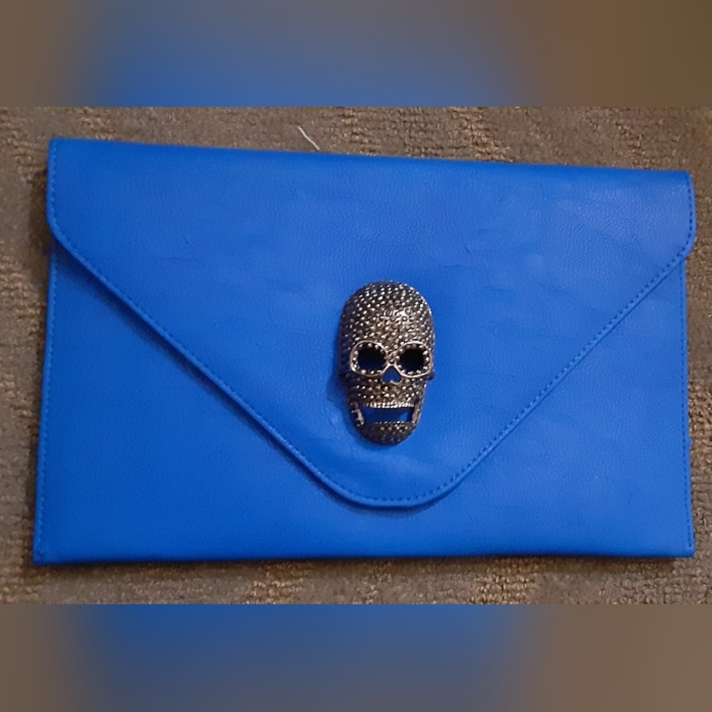 Medium thin silver skull clutch brand new never used.